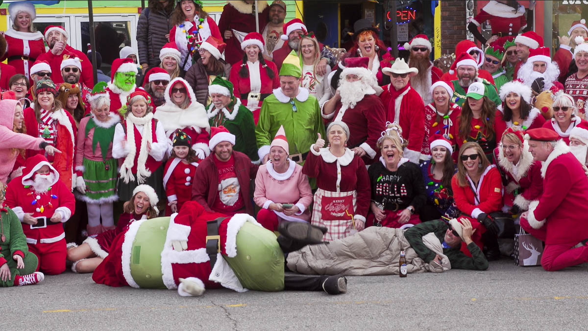 Santas drink their way across downtown Lawrence for charity  The Lawrence Times [Video]