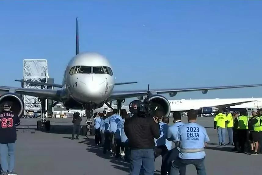 Watch: Airline employees drag jumbo jets for cancer research [Video]